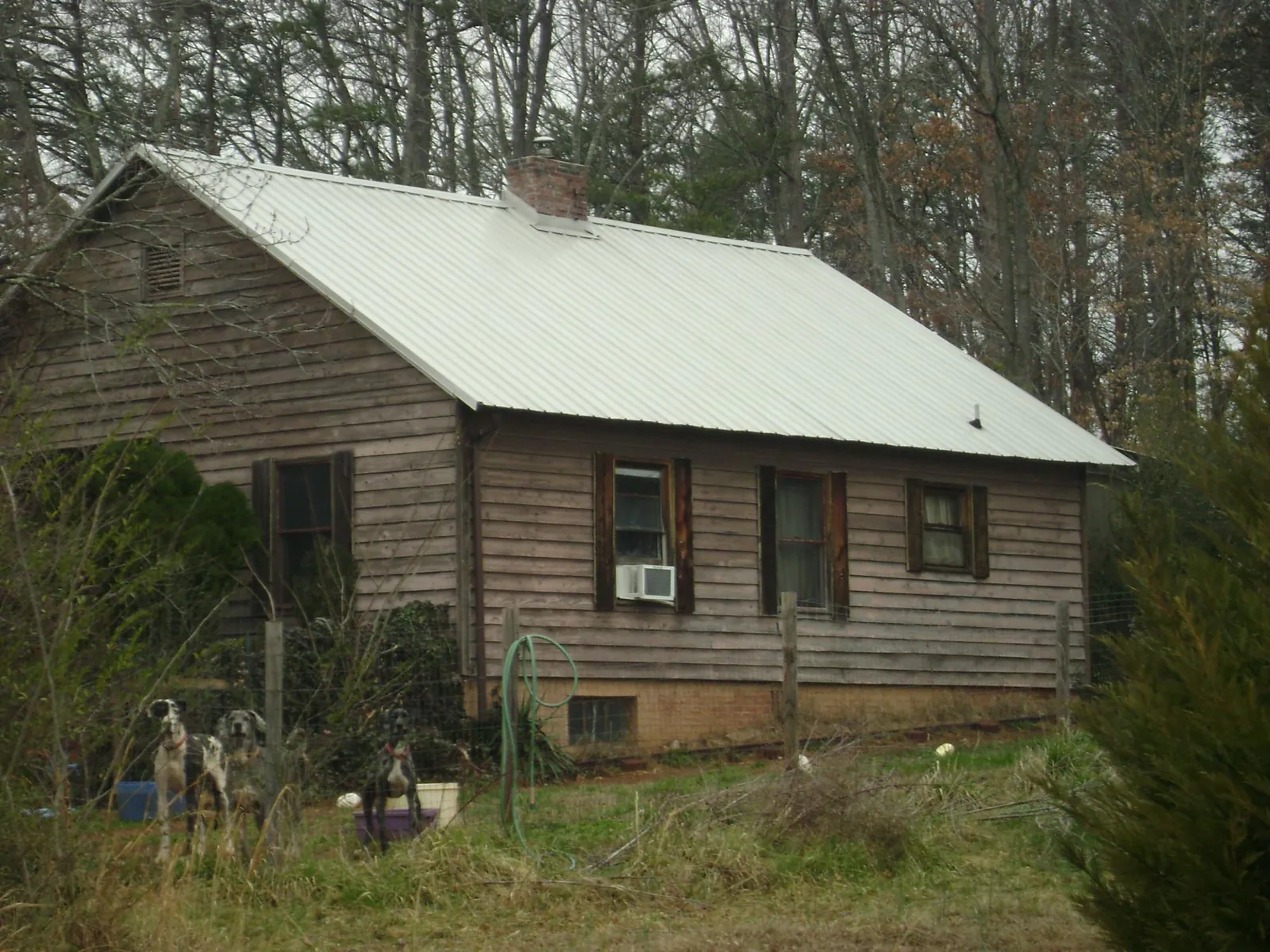 White metal roof on an old wood sided farmhouse, from a Metal Roof Installation job in Judsonia
